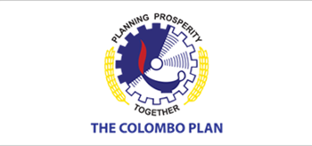 Plan Colombo - Engranaje azul, blanco y rojo rodeado de dos espigas de trigo amarillas, y las palabras “planning prosperity” y “together”.